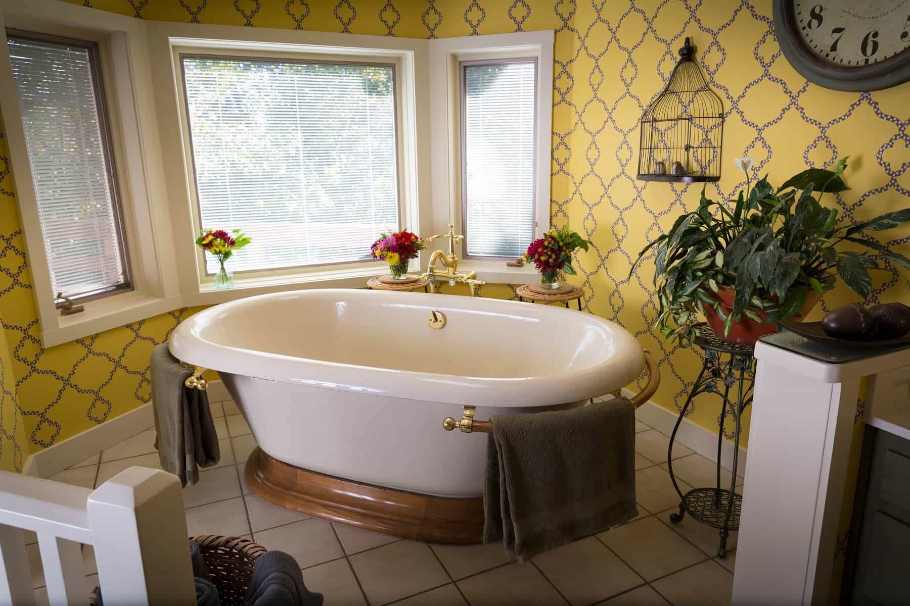  Enjoy a long, relaxing bathin the oversize roman soaking tub in the Sunrise Suite at Country Willows Inn & Estate in Ashland, Oregon, with views of the trees and mountainside. 